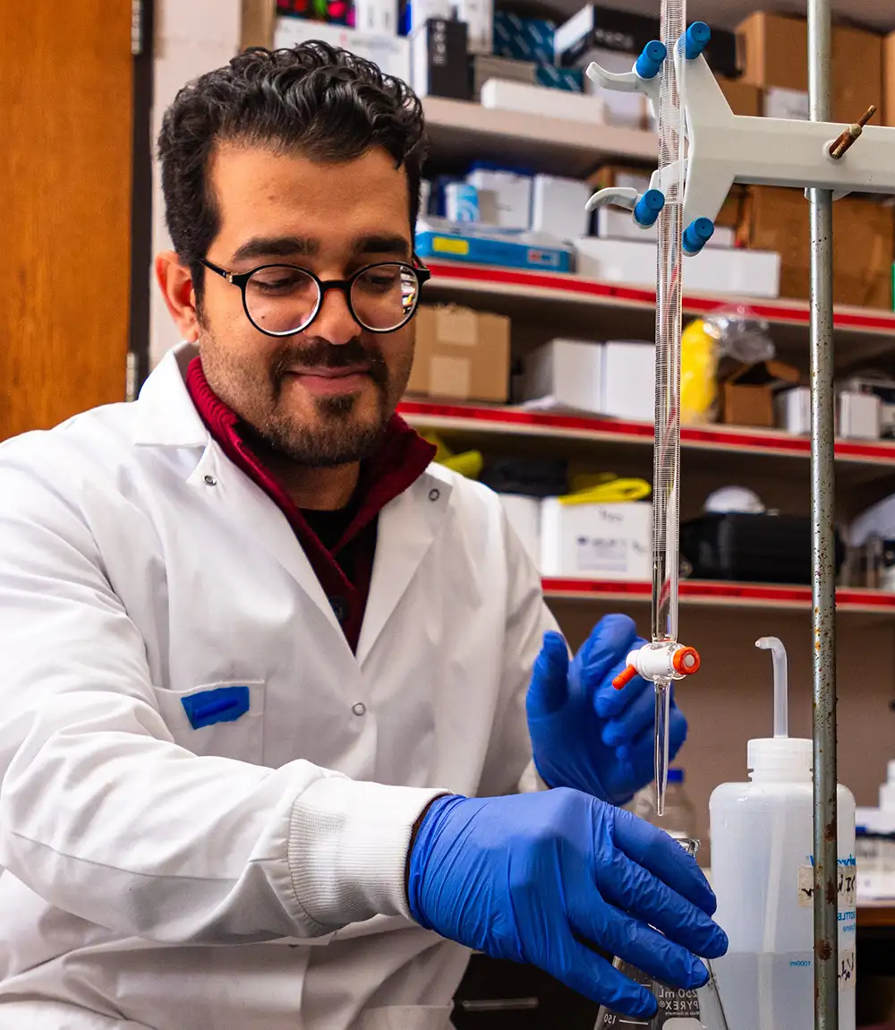 Student working with laboratory glassware.