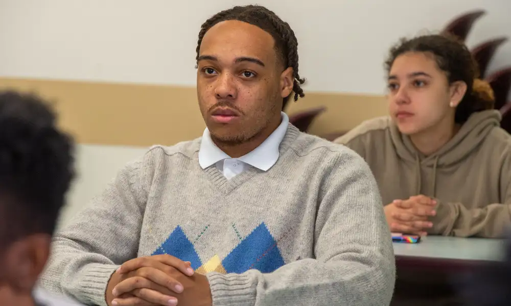 Student listening attentively during a classroom discussion.