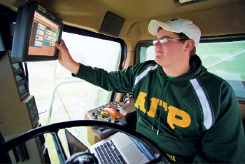 Student operating farm equipment