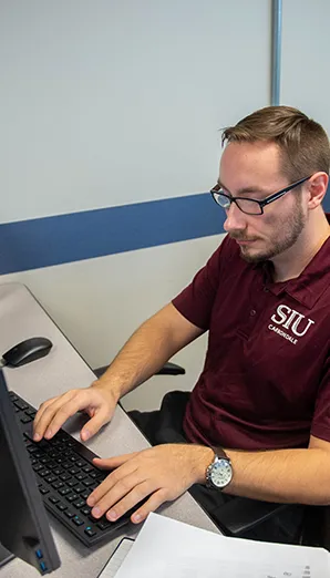 SIU Computer Science Student working on the computer