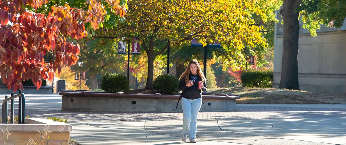 SIU student walking across campus in the fall