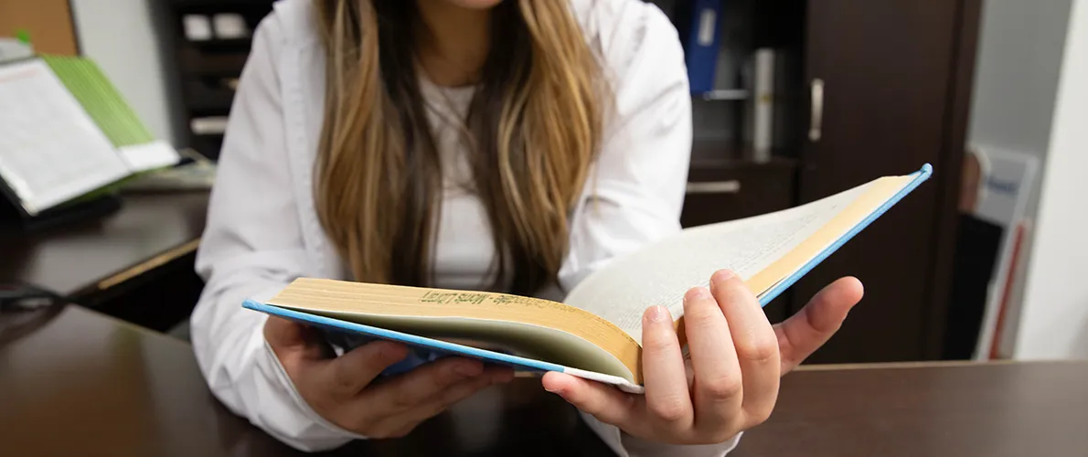 SIU Student reading a book at Morris Library