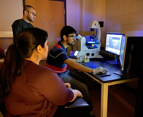 SIU Mechanical Engineering PhD Students working together in lab