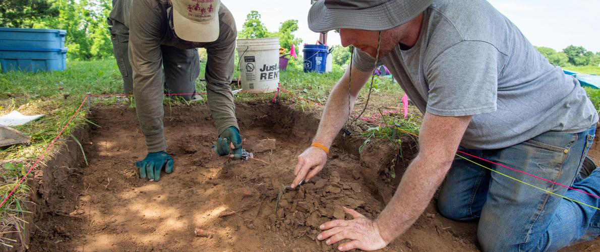 SIU Anthropology Student Searching at a dig site.