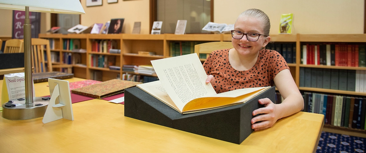 SIU Student reading a book 