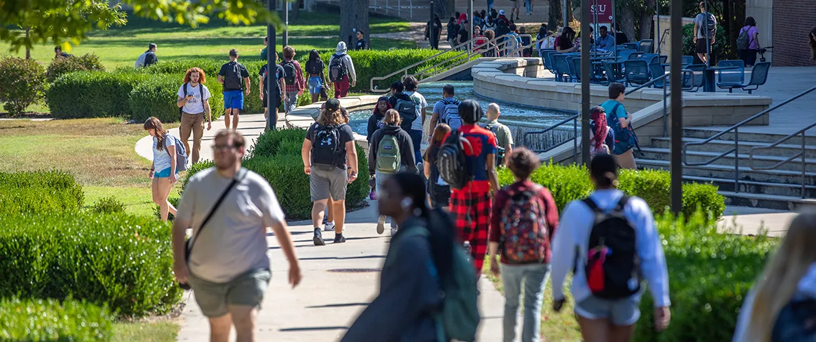 Diverse group of students walking accross SIU campus