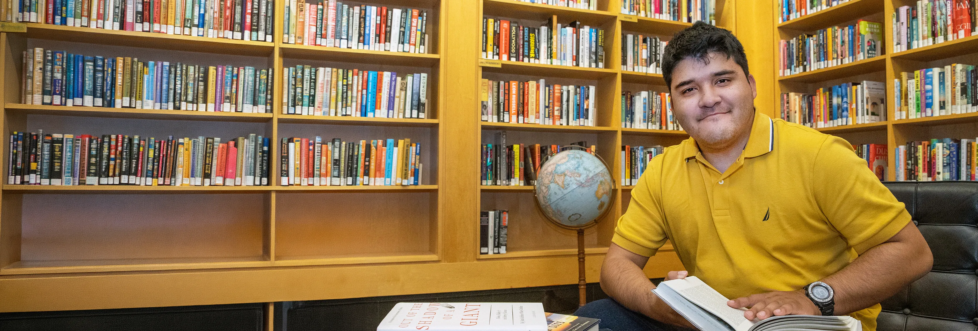 SIU student reading book in Morris Library