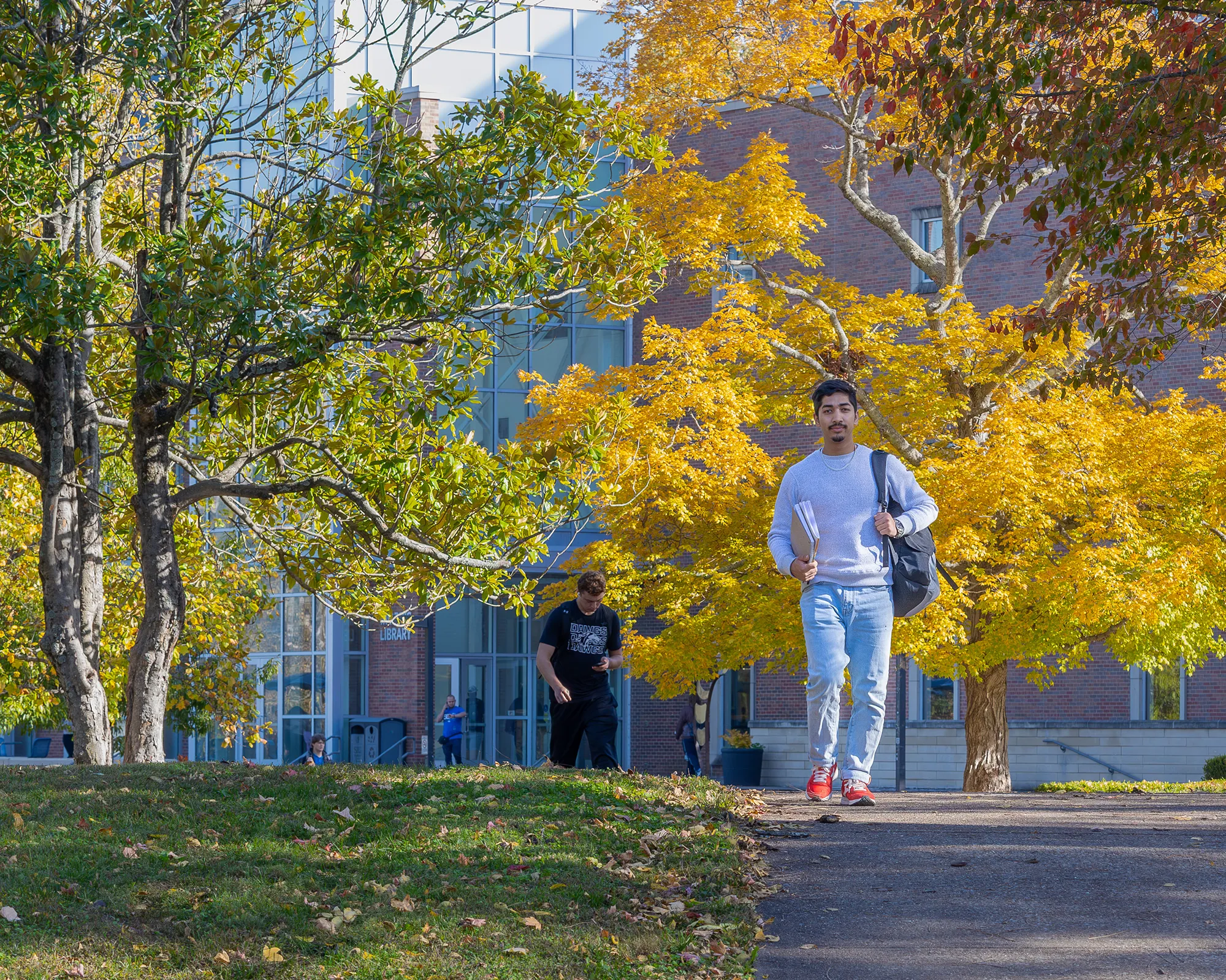SIU student walking across campus in the fall