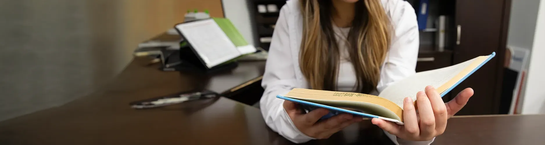 SIU Student reading a book at Morris Library