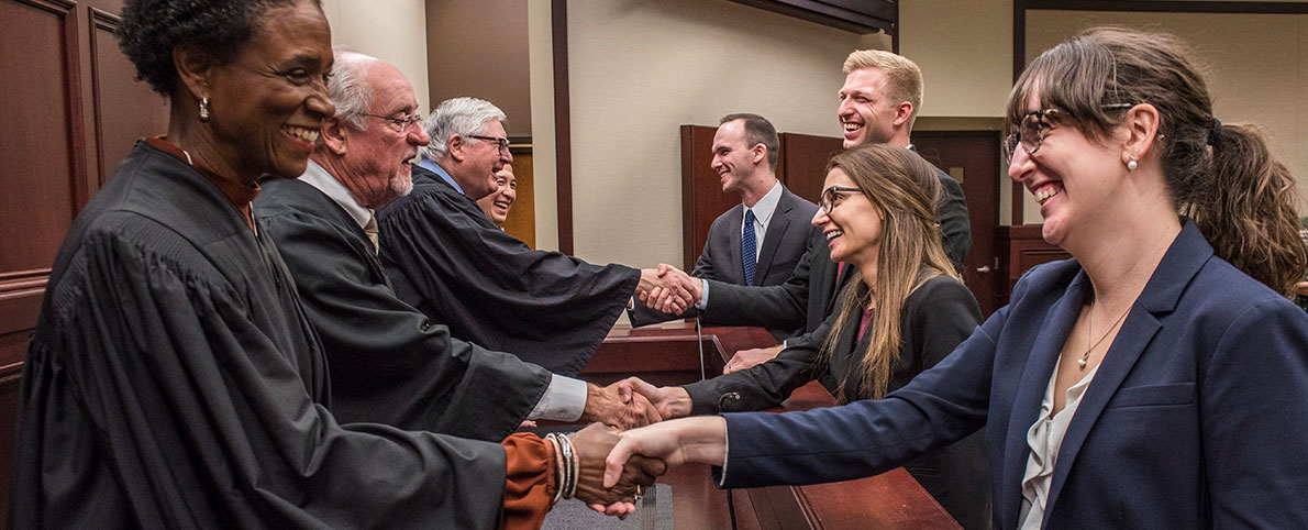 law students shaking hands with judges