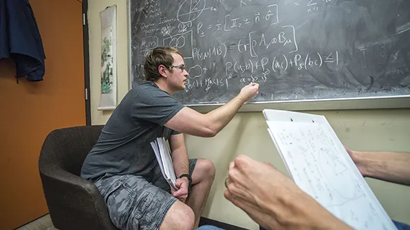 SIU Physics Student working on formula.